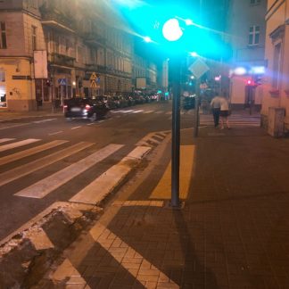 Street corner, night, traffic, several car passes, people walking and running, Poznan, Poland