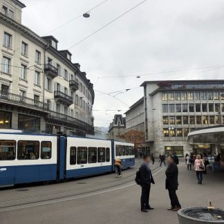 Tramway hub, slightly busy, tramways arriving and departing, traffic, people walking by, talking, Zurich, Switzerland